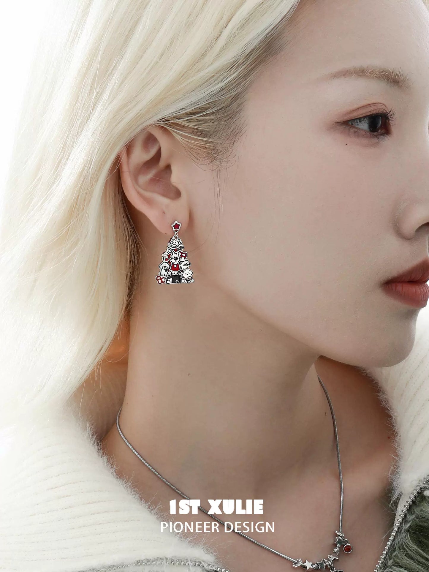 Christmas dog earrings designed in the shape of a festive tree with colorful details and sparkly accents