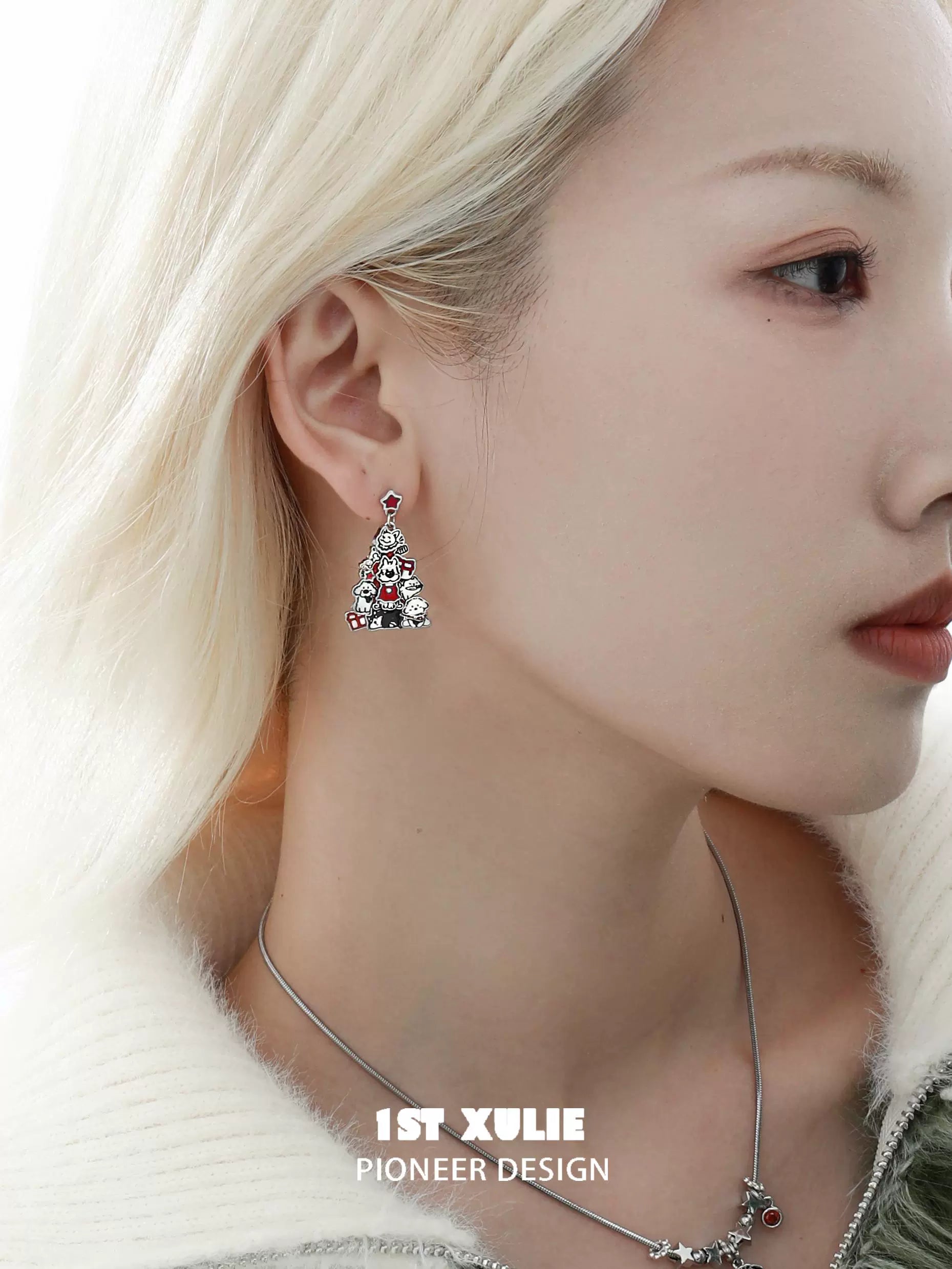 Christmas dog earrings designed in the shape of a festive tree with colorful details and sparkly accents