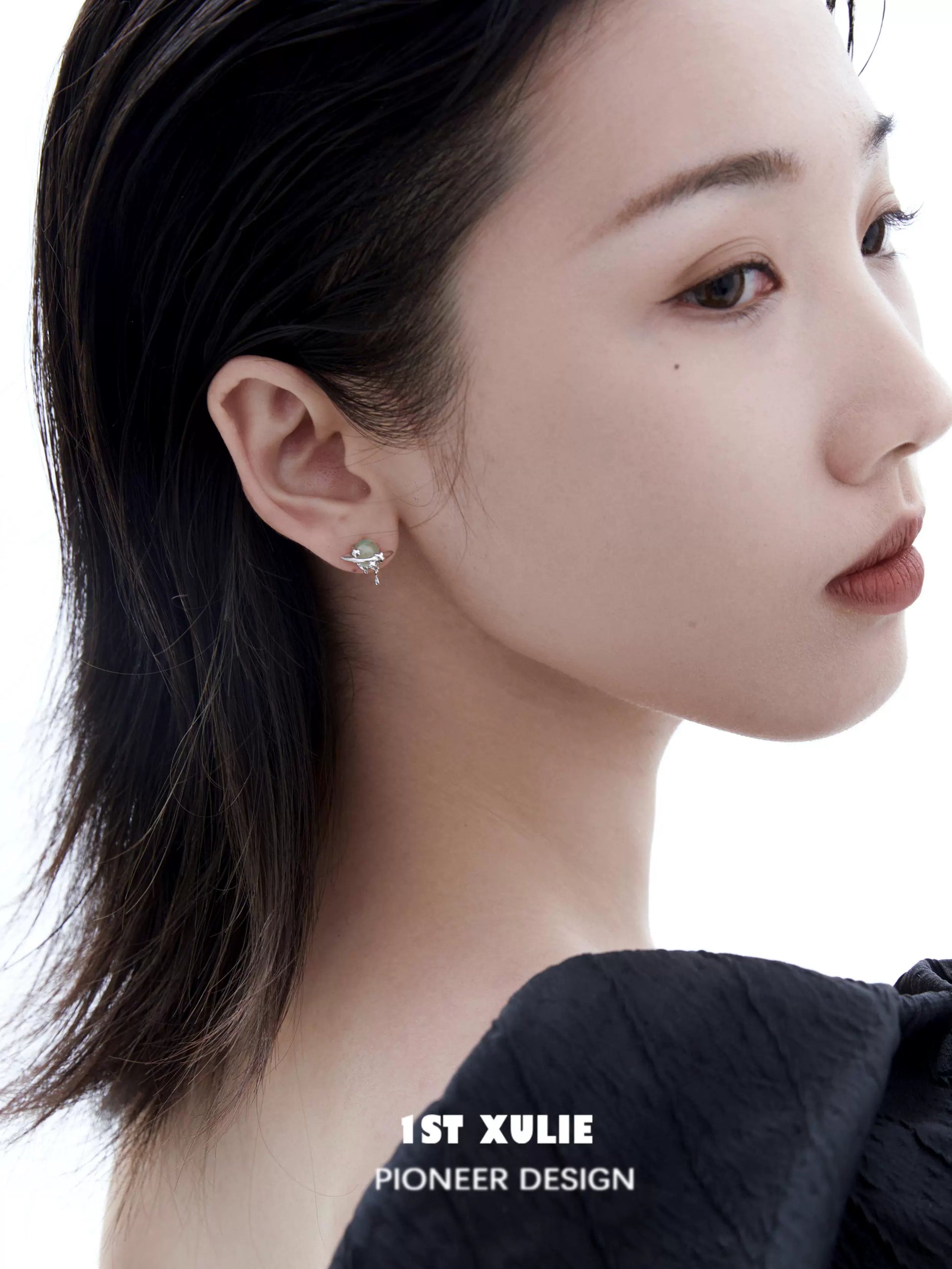 Elegant cosmic meteorite earrings showcased on a model with a sleek hairstyle