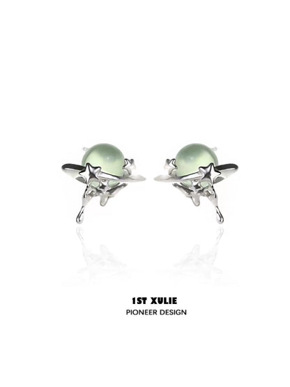 Elegant cosmic meteorite earrings featuring silver stars and green gemstones for a celestial look