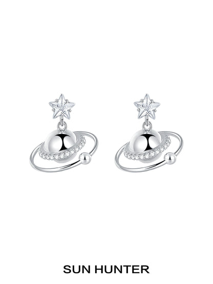 SUN HUNTER cosmic planet star earrings featuring a star and planet design with sparkling accents
