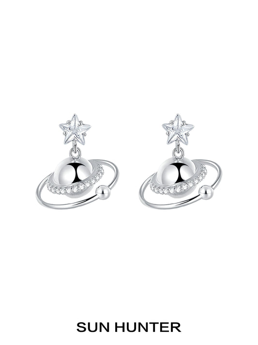 SUN HUNTER cosmic planet star earrings featuring a star and planet design with sparkling accents