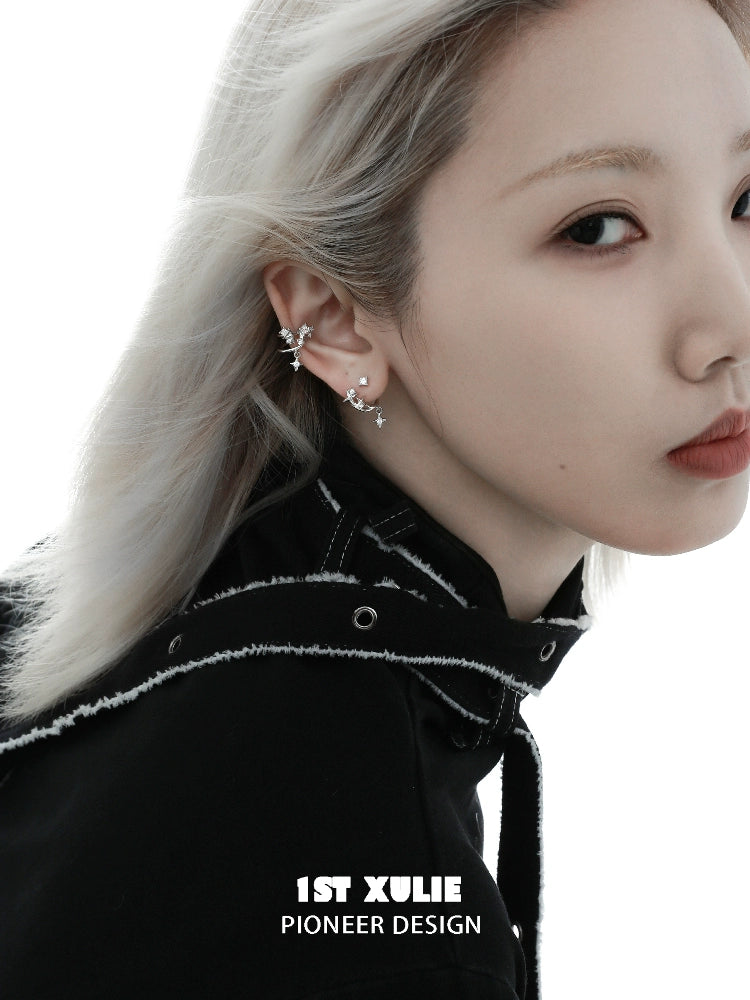 Stylish model wearing a cosmic star ear cuff with a chic black outfit and sleek hairstyle