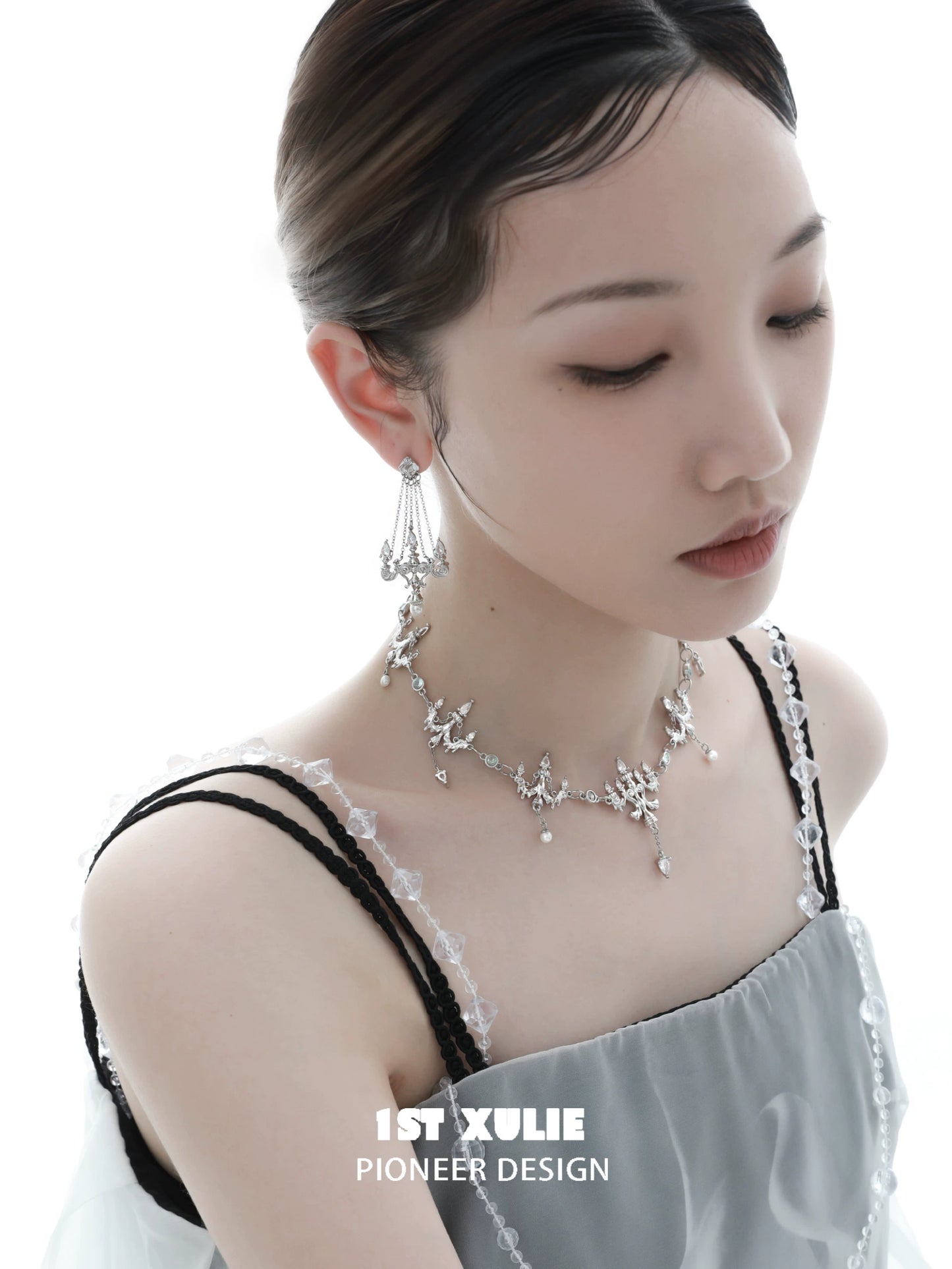 Elegant crystal fringe necklace designed by 1STXULIE, showcasing shimmering details worn by a model