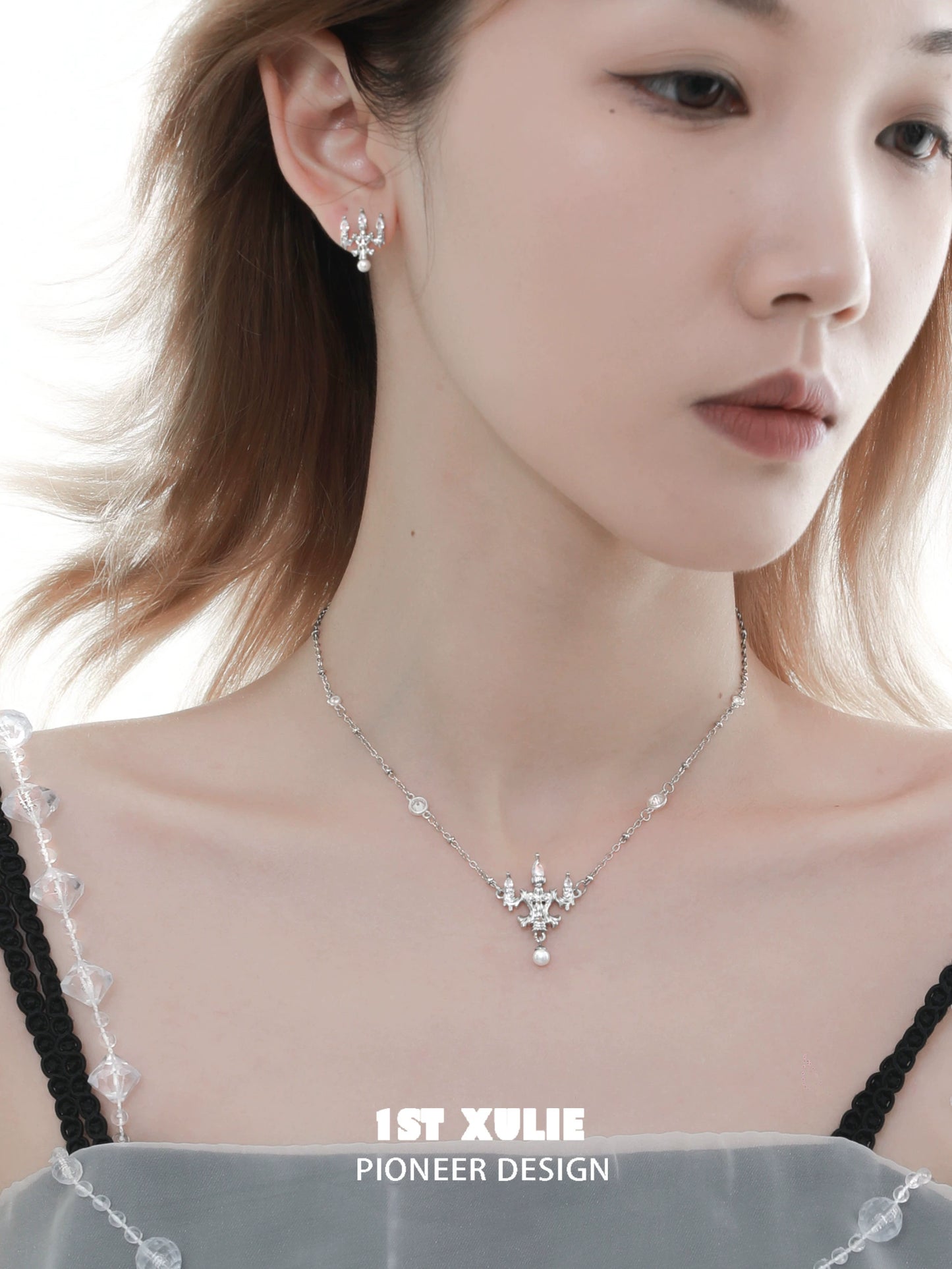 Elegant model showcasing a crystal lamp silver necklace with matching earrings from 1ST XULIE