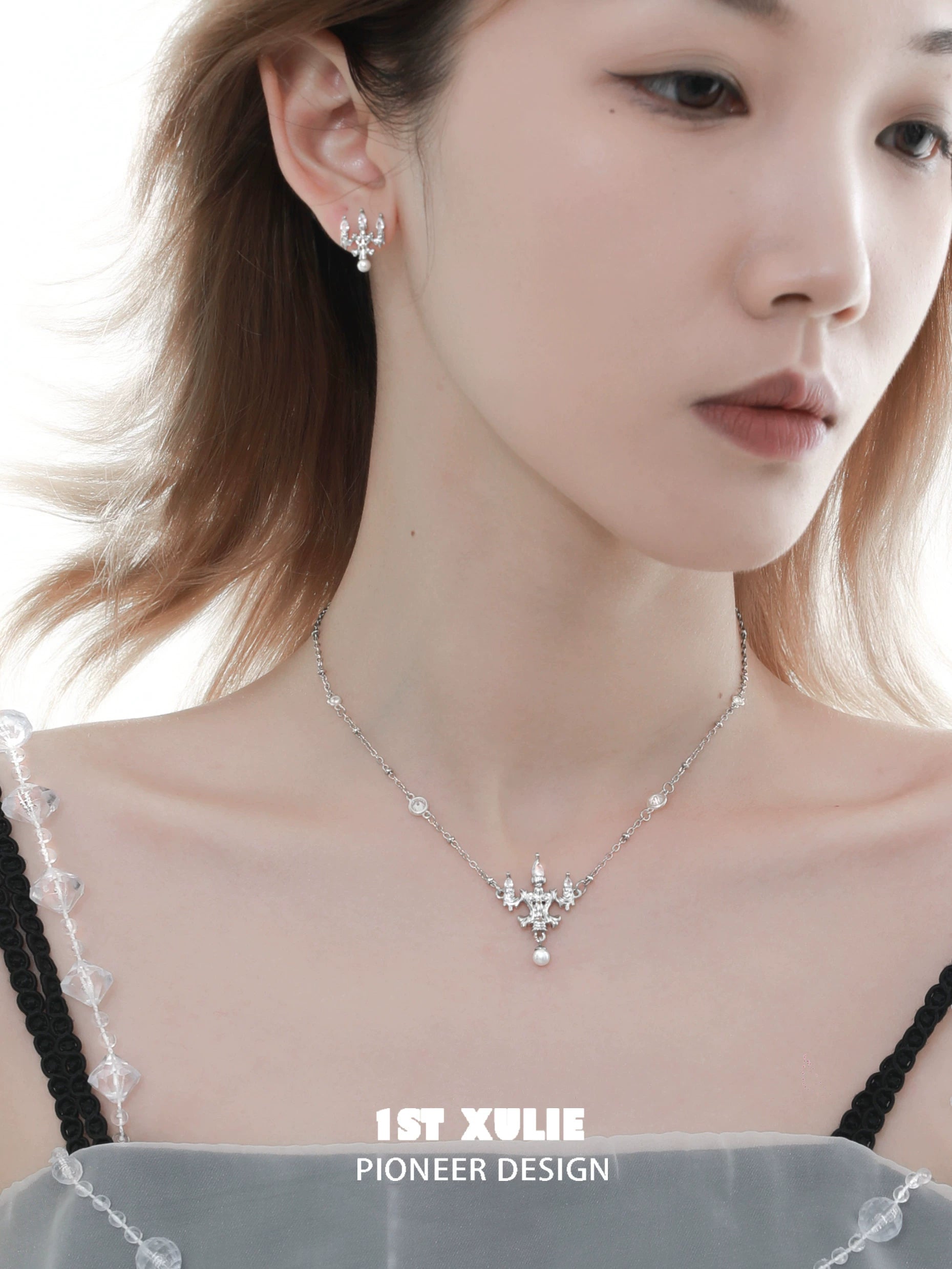 Elegant model showcasing a crystal lamp silver necklace with matching earrings from 1ST XULIE