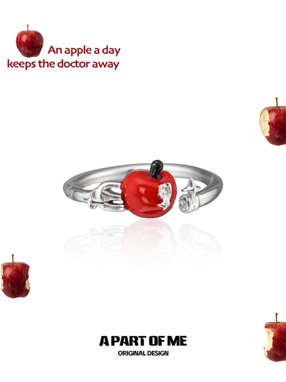 Cute apple ring with a shiny red apple charm on a silver band, ideal for fruit lovers