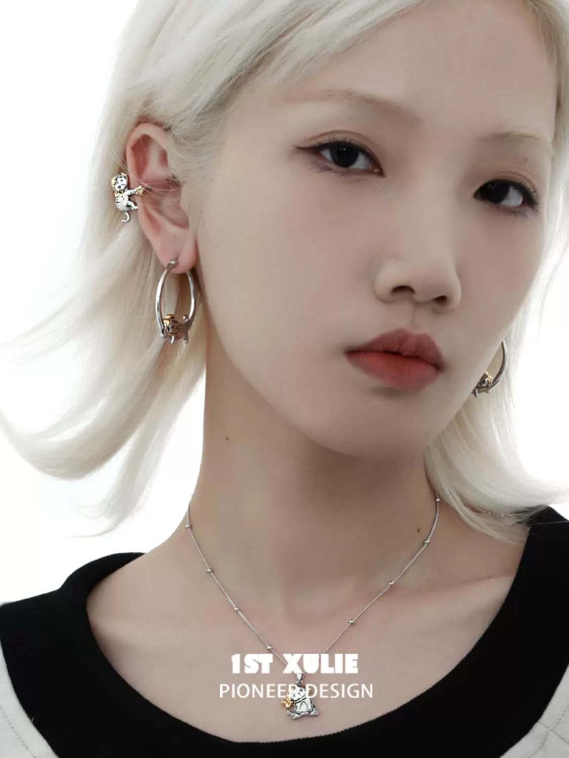 Fashionable cute cat ear clips worn by a person with a stylish outfit and jewelry