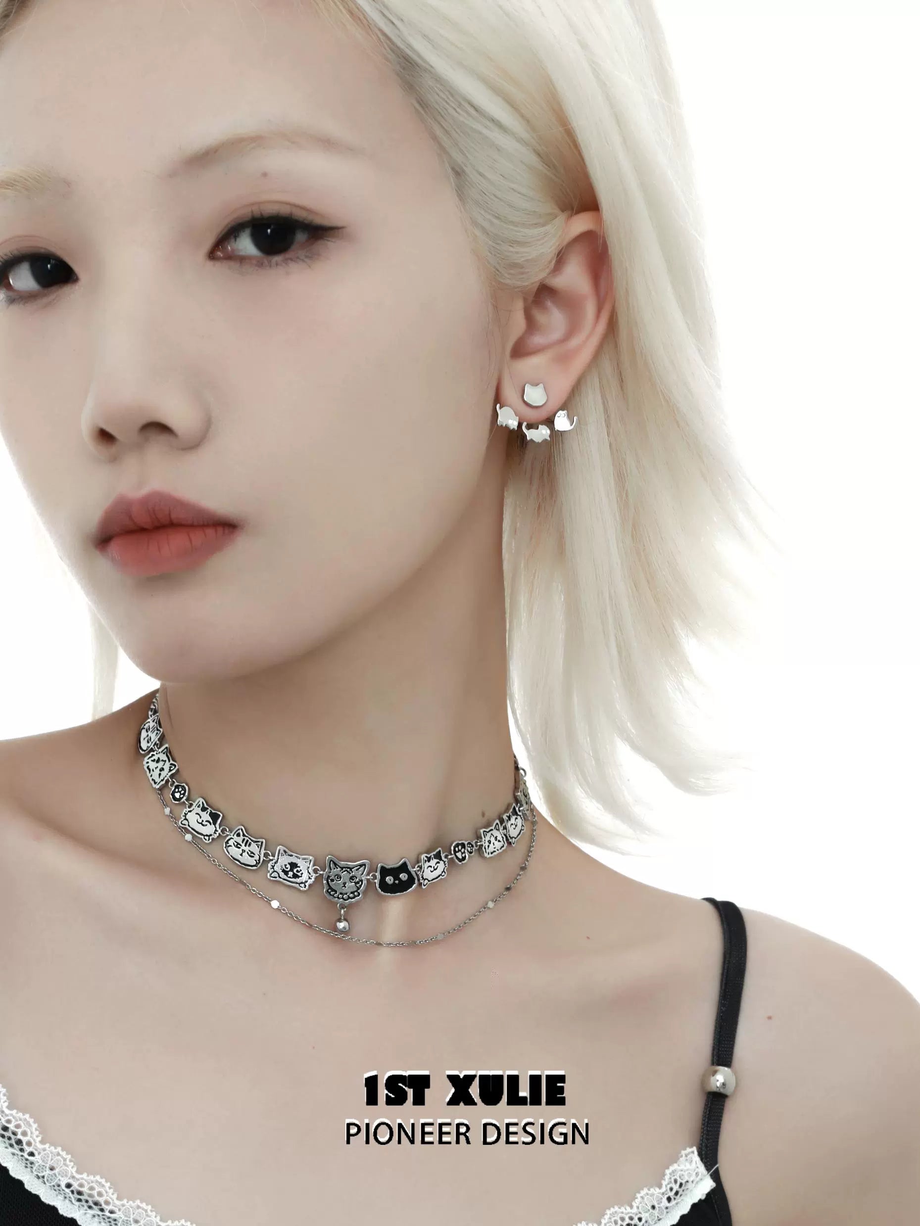 Stylish model wearing cute cat earrings removable, complementing a trendy choker necklace by 1STXULIE