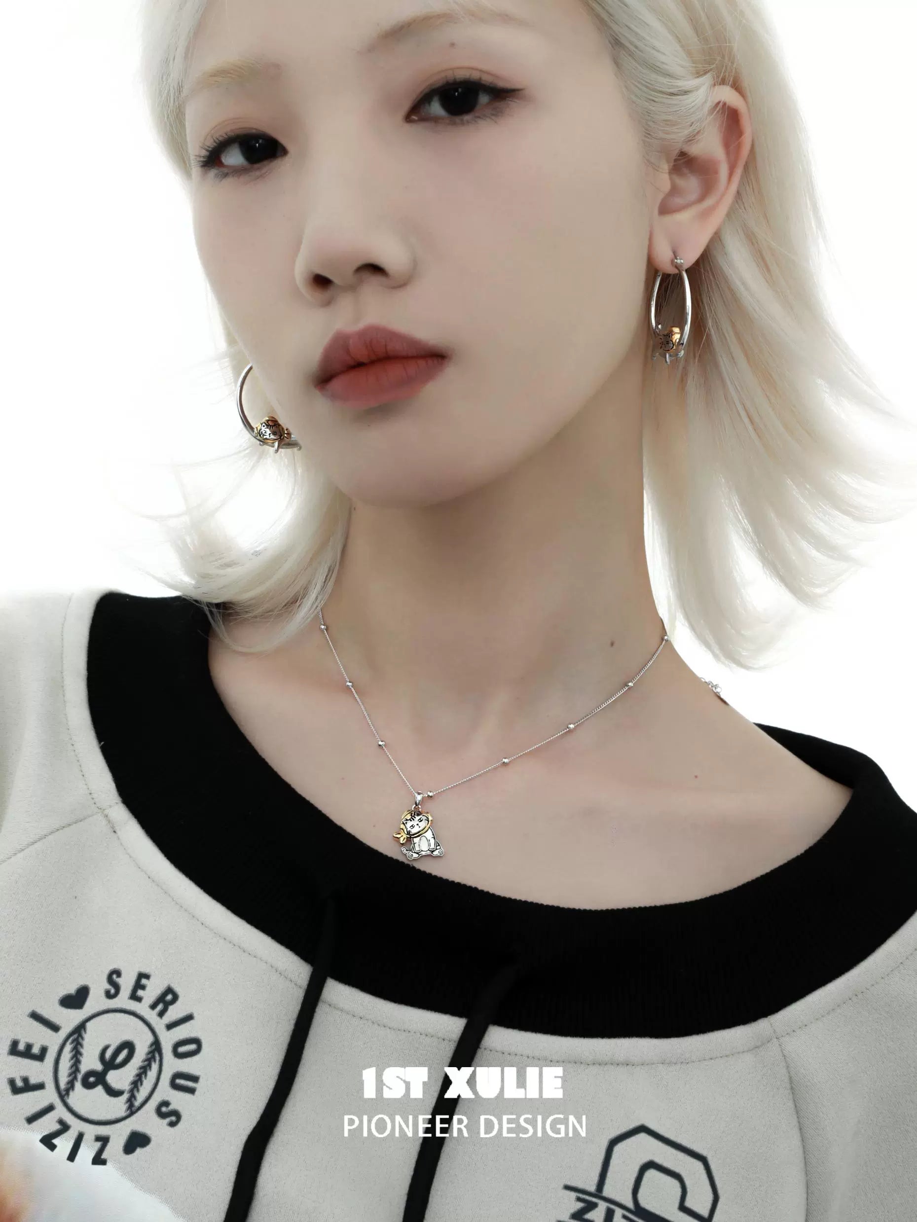 Model wearing cute cat hoop earrings with a stylish outfit and soft makeup for a trendy look