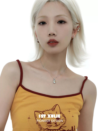 Cute cat necklace worn by a model, showcasing a charming feline design in a chic setting