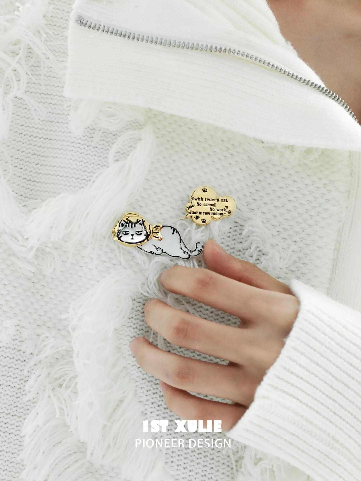 Cute cat silver brooch featuring a playful cat illustration on a stylish sweater