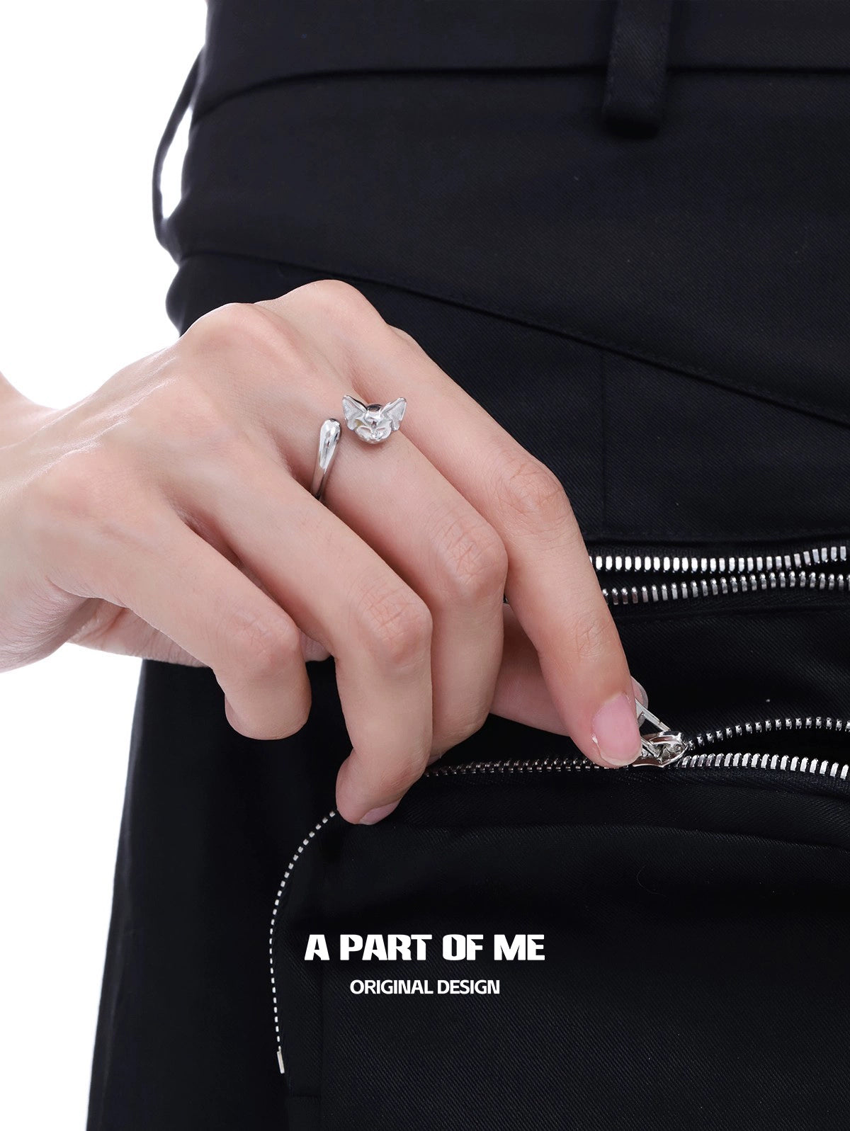 A hand wearing a cute cat tail silver ring, showcasing a unique and stylish design