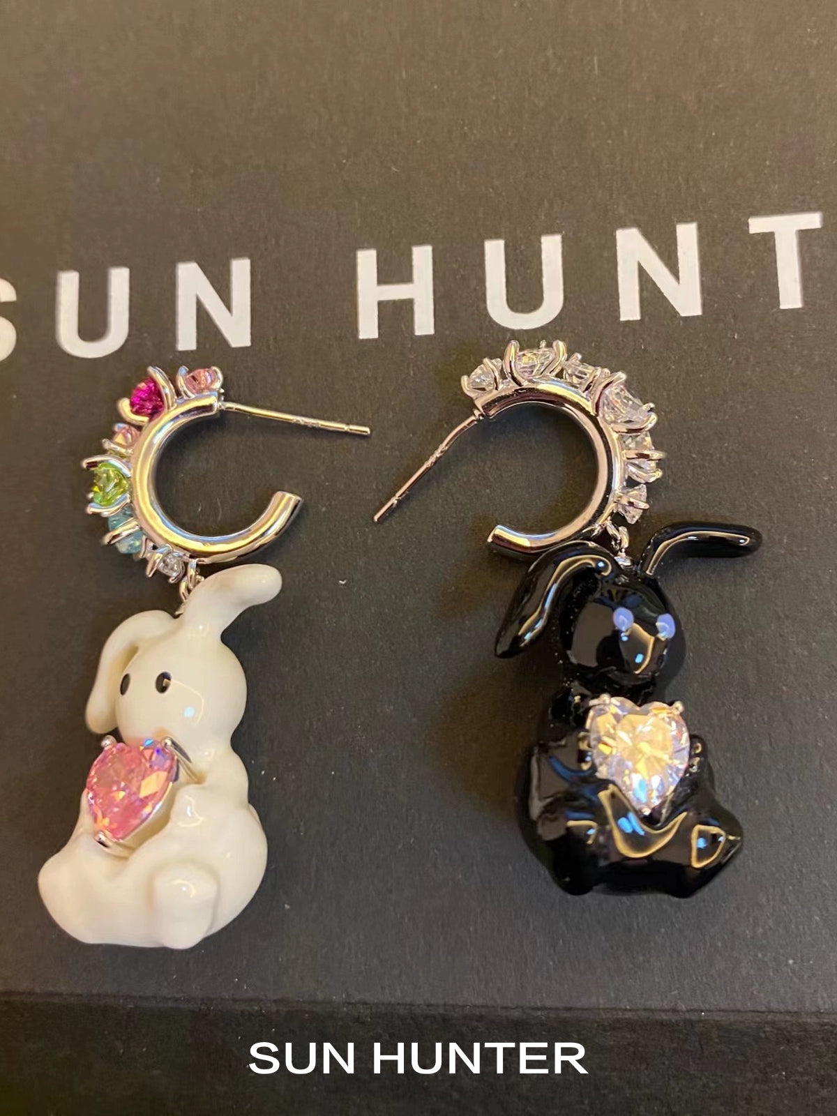 Cute enamel rabbit earrings featuring a white and black bunny with sparkling gems