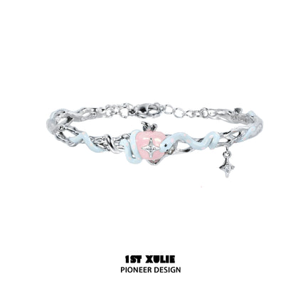 Cute snake apple bracelet featuring a pink heart charm and silver accents for a playful accessory