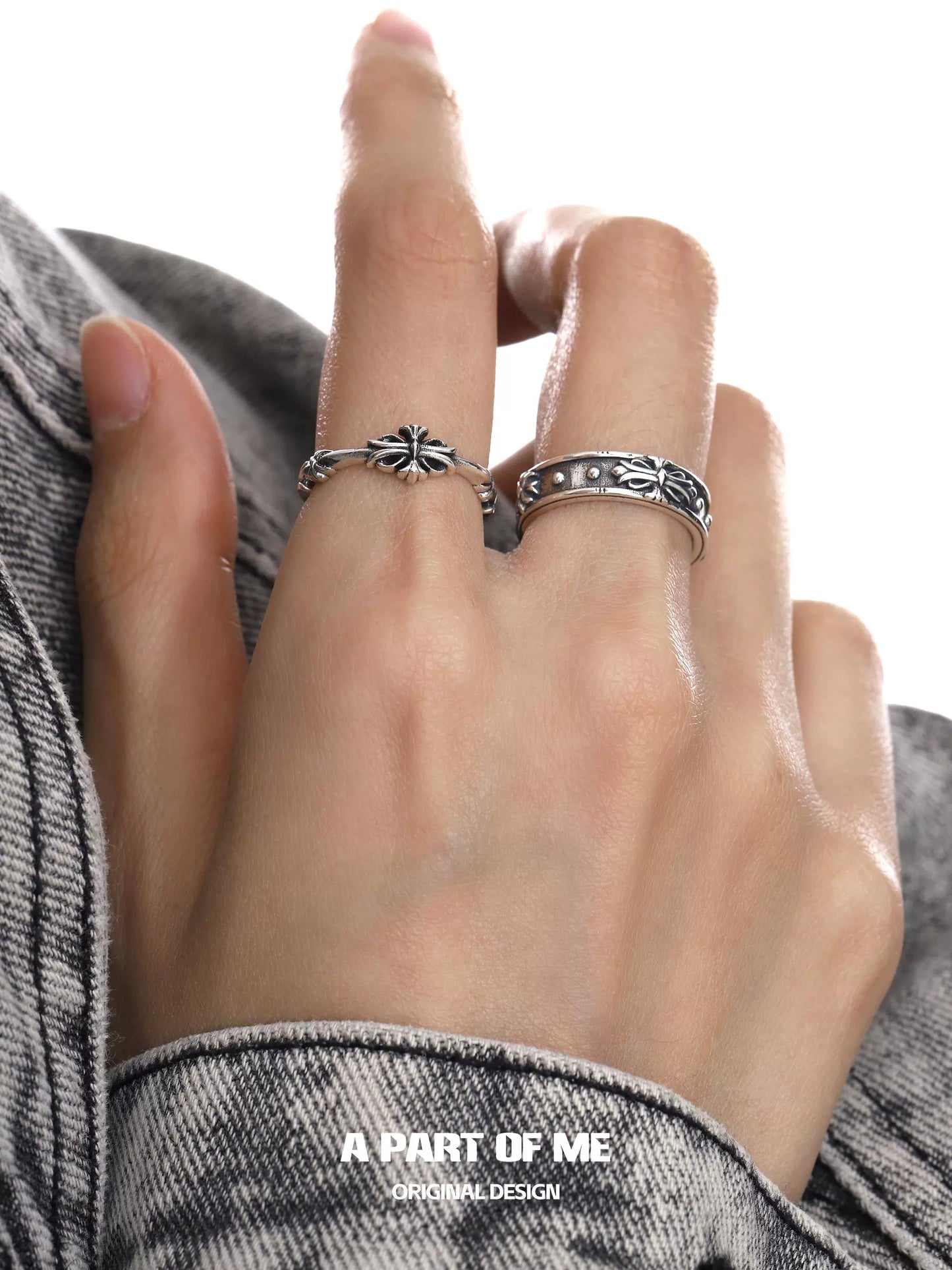 Stylish hand wearing a dark iris vintage ring and a matching silver band from A PART OF ME