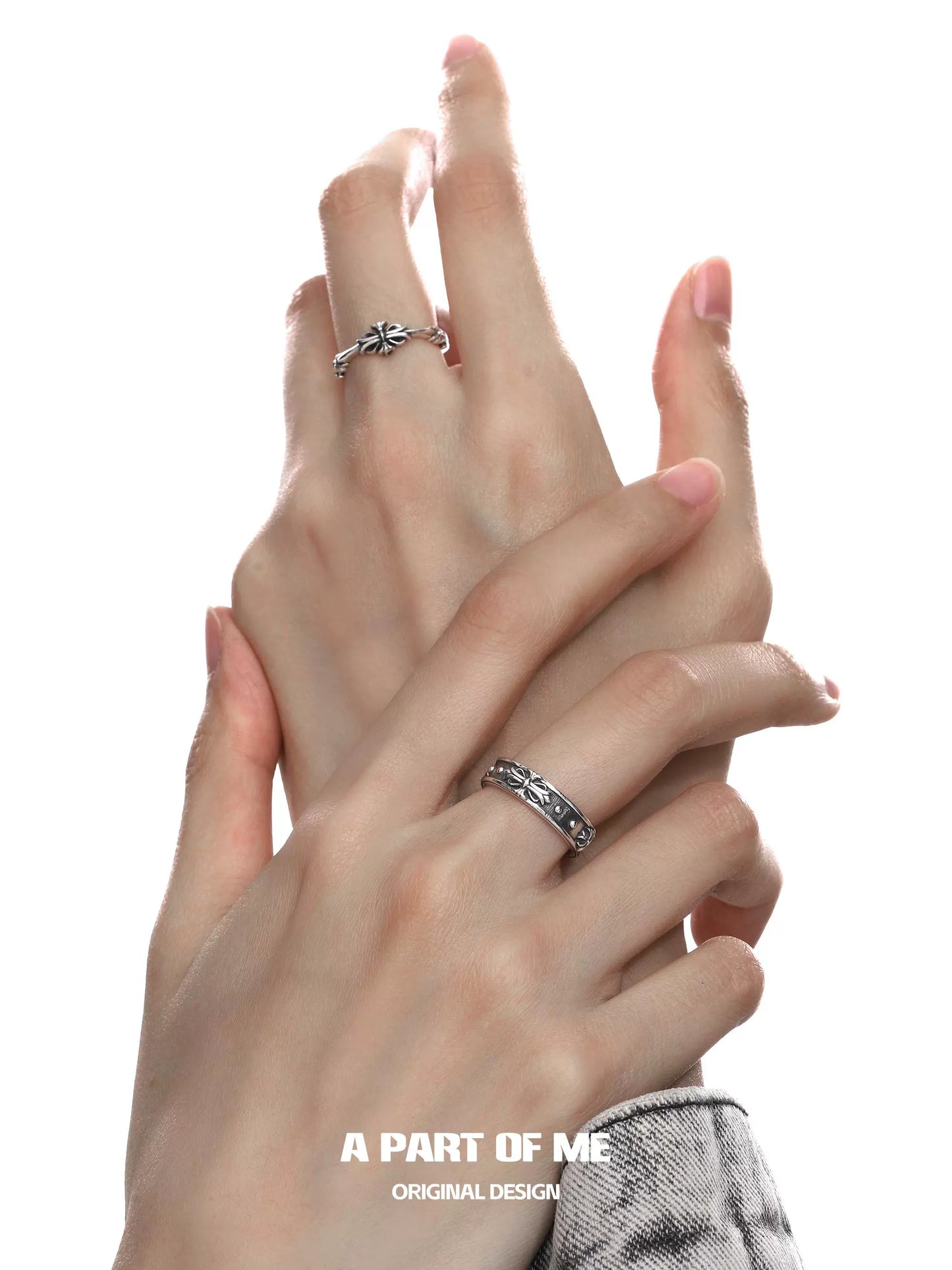 Elegant hands showcasing a dark iris vintage ring from A PART OF ME with floral designs