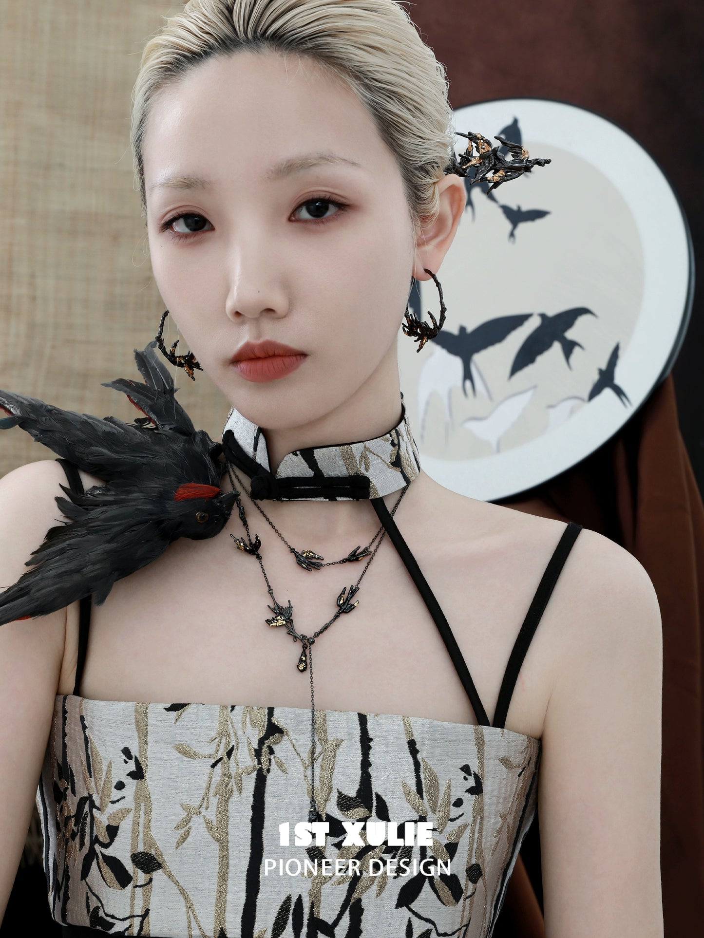 Elegant dark swallow necklace paired with a stylish outfit featuring artful designs and accessories