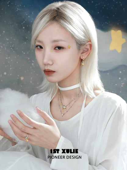 Model wearing a double layered star necklace with a soft and ethereal look, perfect for trendy outfits.