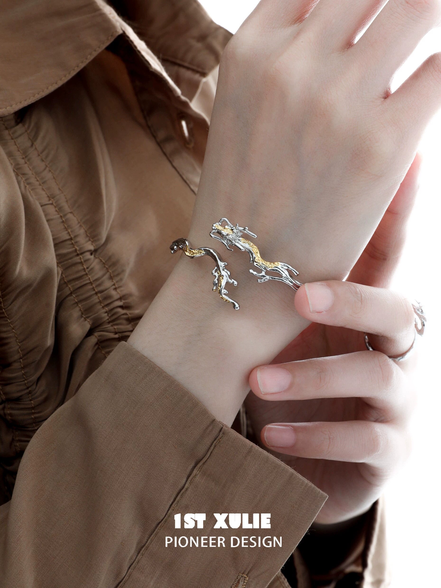 Stylish silver and gold dragon bracelet for women, showcasing intricate design on the wrist