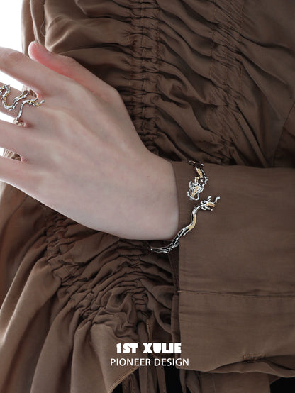 Stylish silver dragon bracelet for women featuring an intricate design on a model's wrist