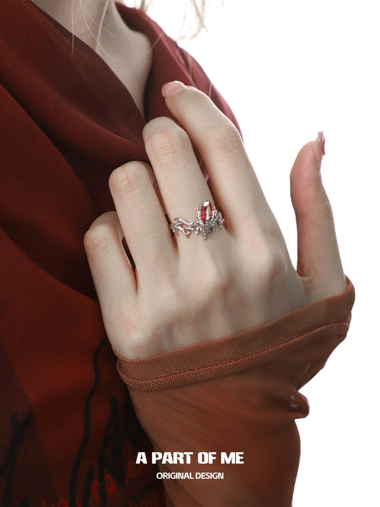 A PART OF ME dragon claw ruby ring displayed on a hand with stylish nail art