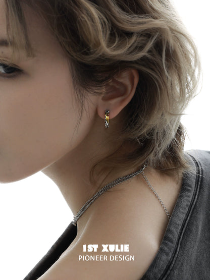 Edgy love letter earrings featured on a model for a fashionable look