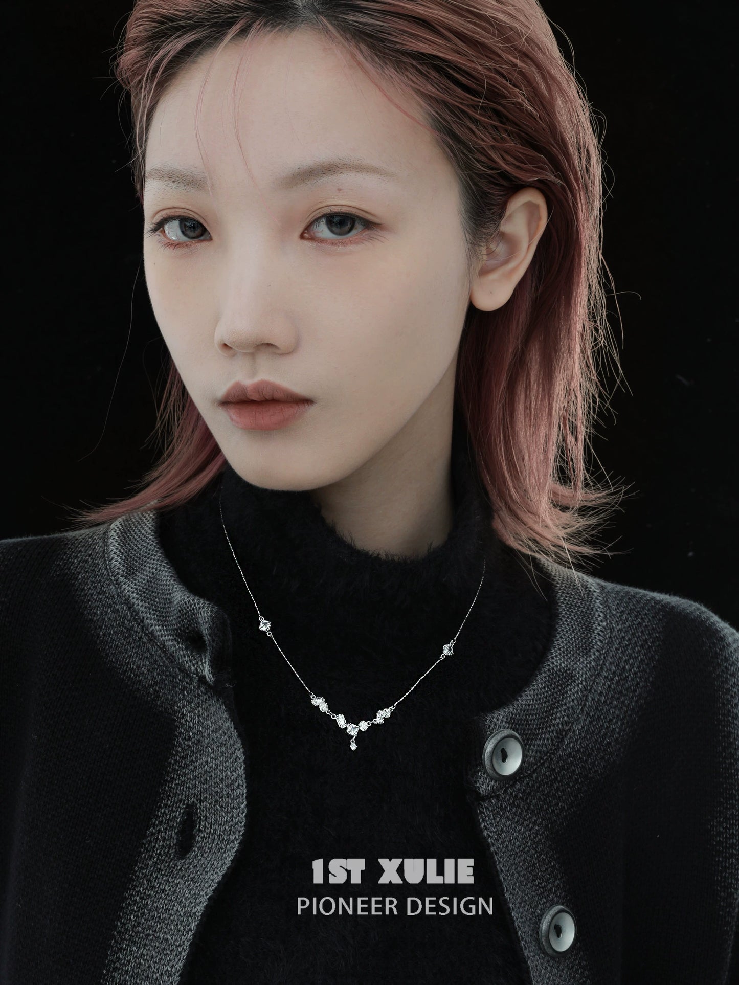 Model wearing an edgy zircon necklace from 1STXULIE with a stylish black outfit