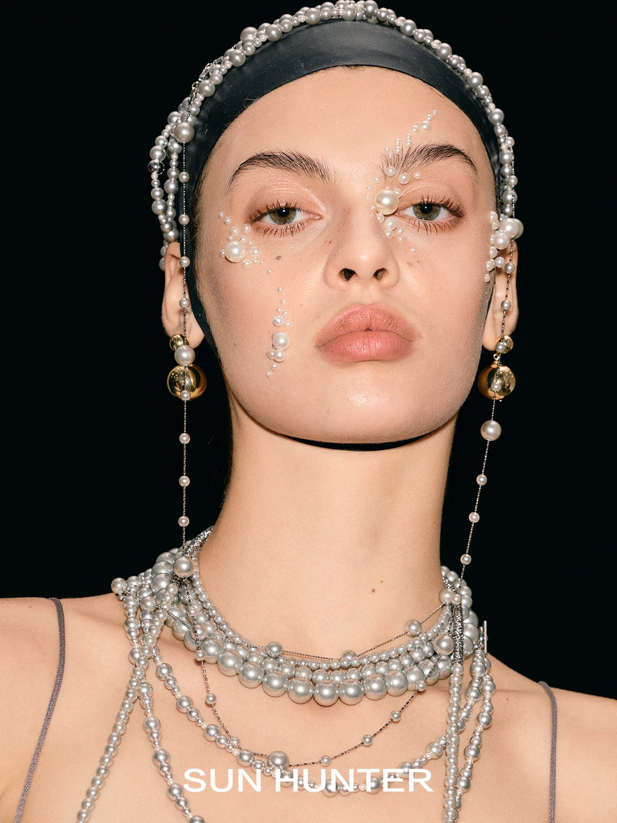 Elegant pearl statement ring showcased in a model's jewelry collection by SUN HUNTER