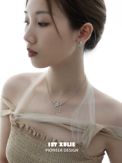 Elegant queen fringe earrings in silver, styled with a matching necklace for a chic look