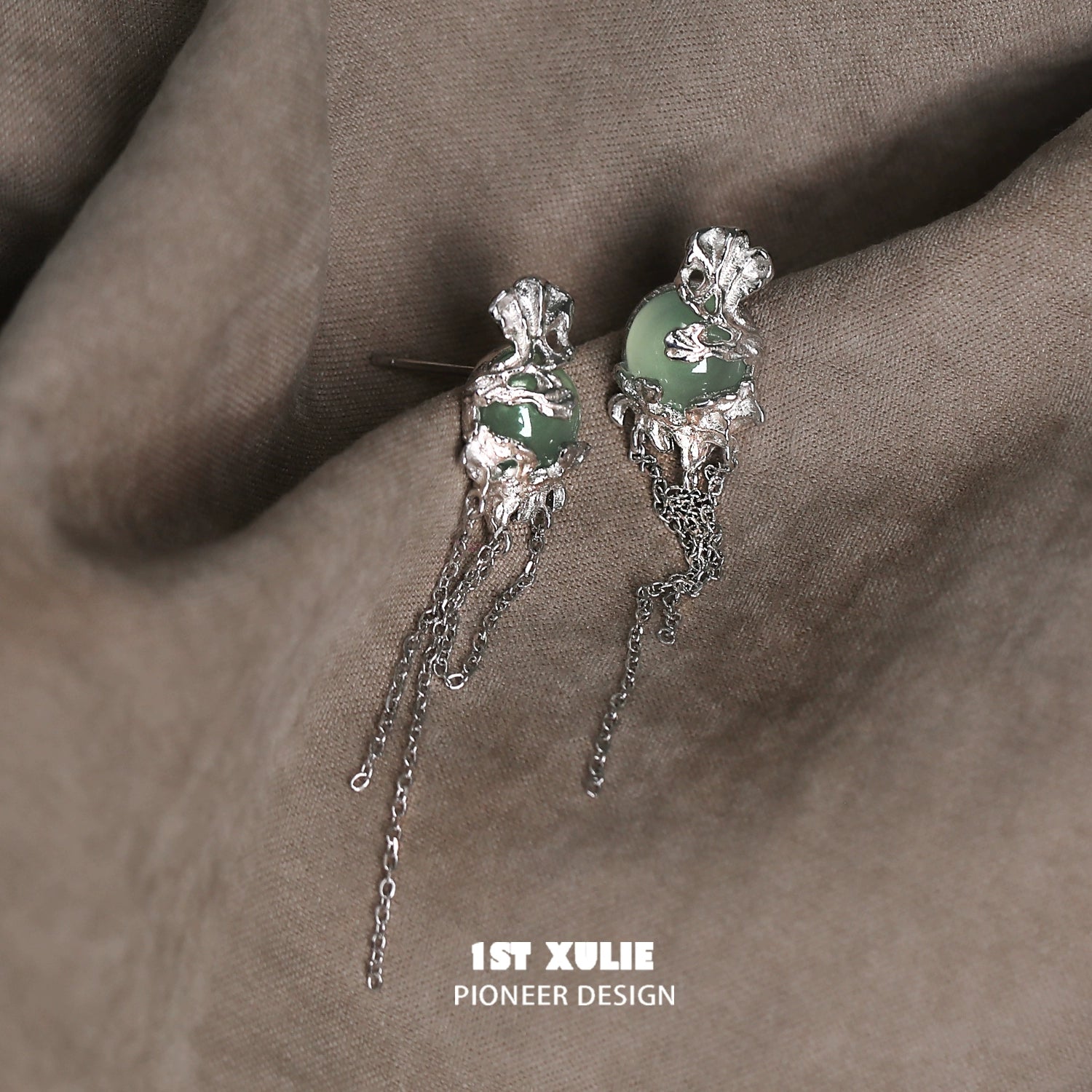 Elegant queen fringe earrings with green gemstone and silver accents for a sophisticated look