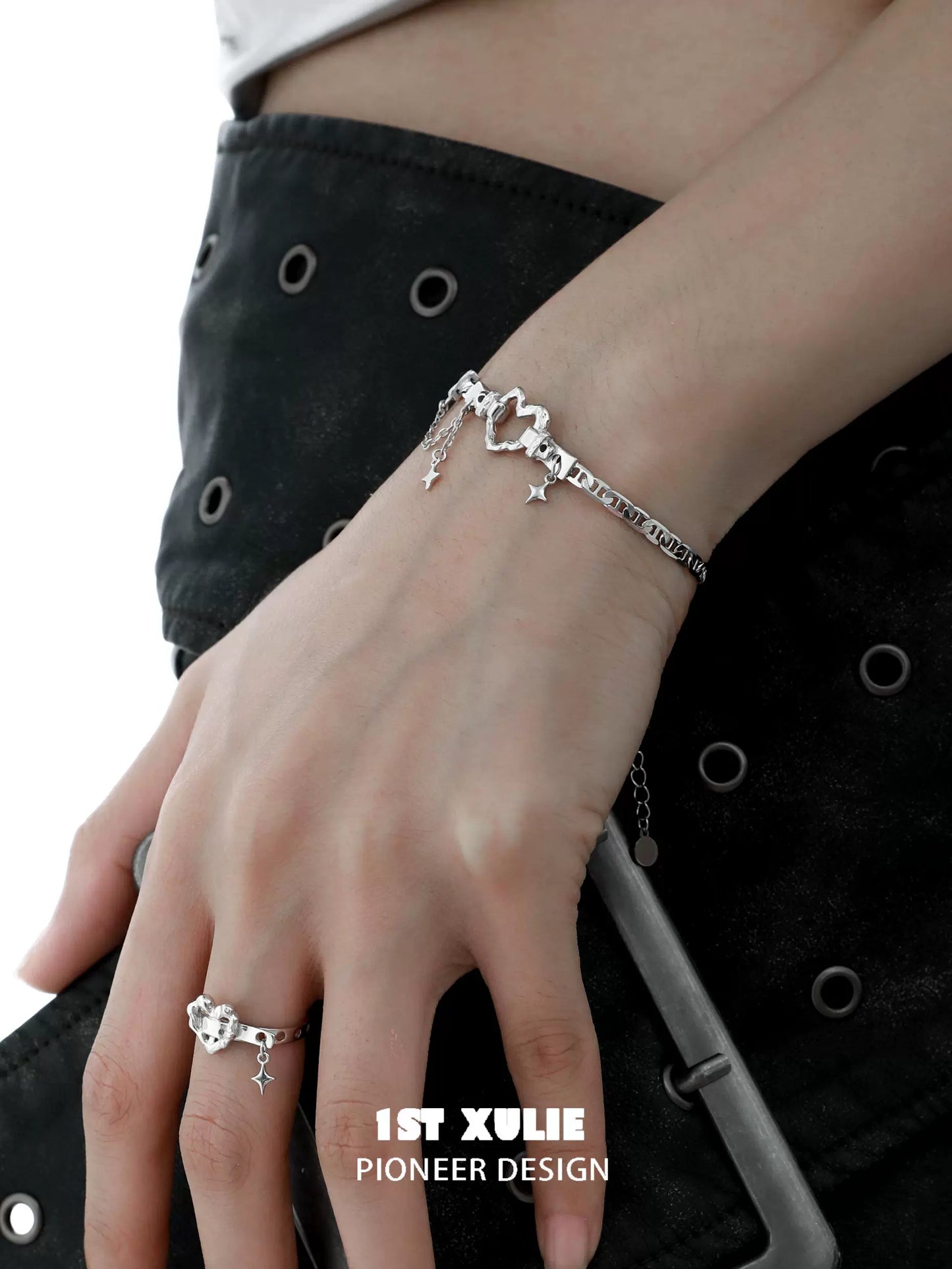 Eternal love heart silver bracelet designed by 1ST XULIE, elegantly worn on a model's wrist