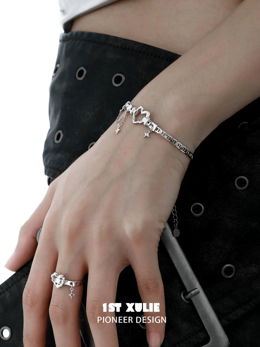 Eternal love heart silver bracelet designed by 1ST XULIE, elegantly worn on a model's wrist