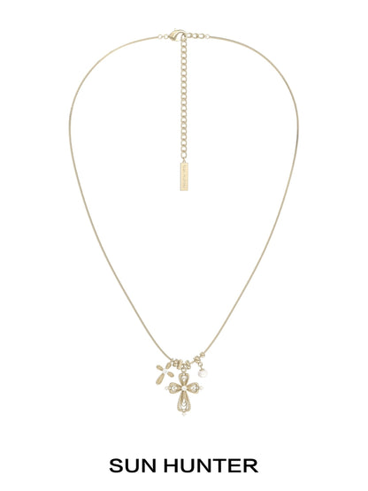 Sun Hunter faith charm necklace featuring a delicate cross and charm design in gold