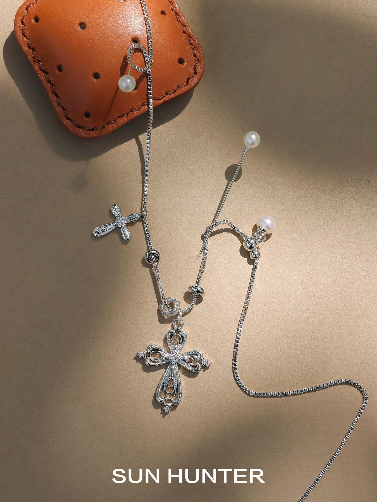 SUN HUNTER faith charm necklace with intricate cross pendant and elegant pearl accents