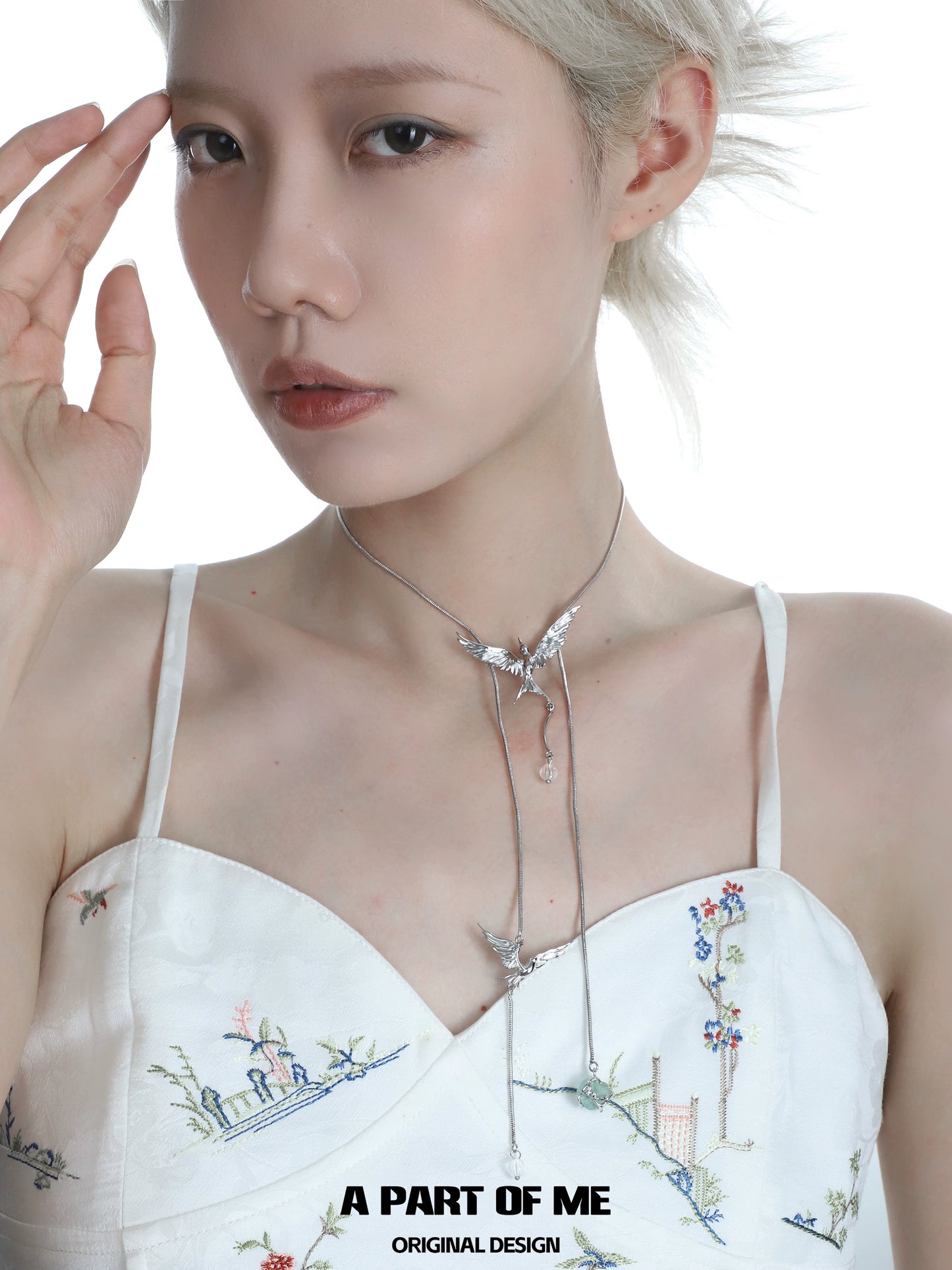 Model wearing a flying bird fluorite necklace featuring elegant silver chains and colorful fluorite stones