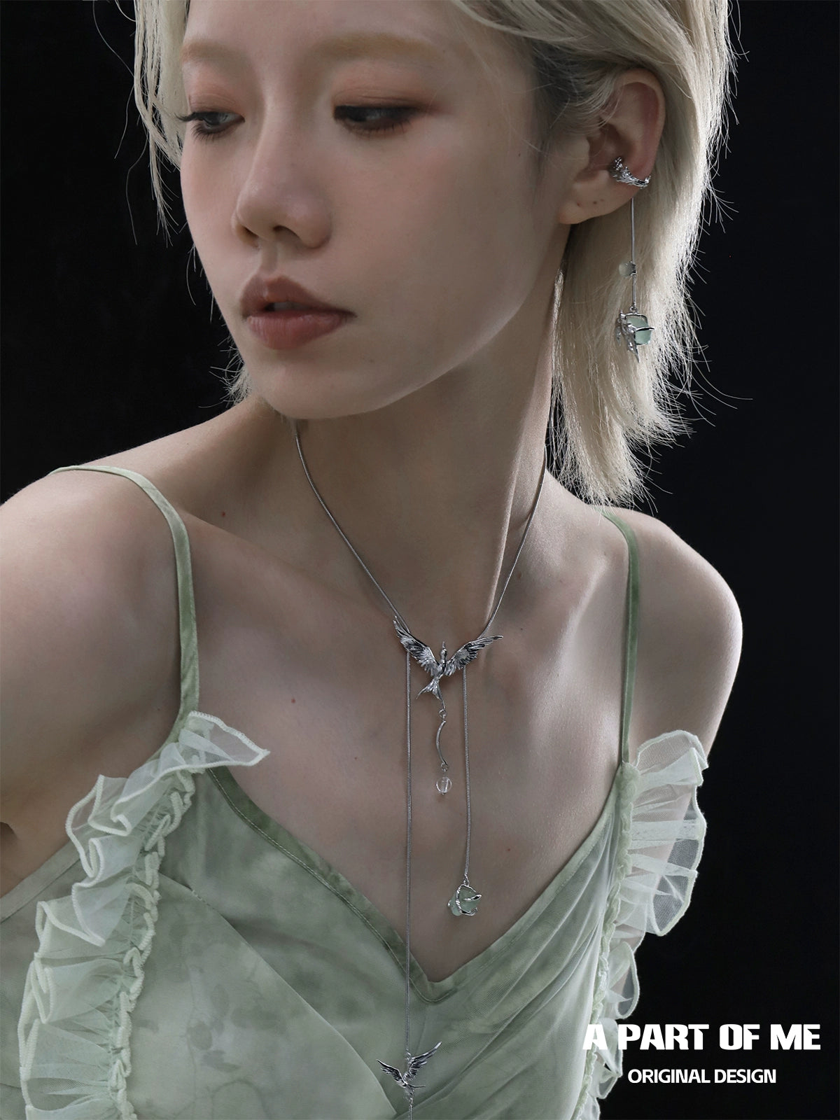 Elegant model wearing a flying bird fluorite necklace paired with a matching earring set