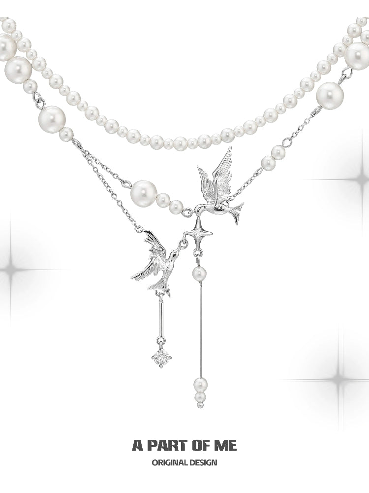 A PART OF ME flying bird pearl necklace featuring elegant design with silver accents and pearl strands