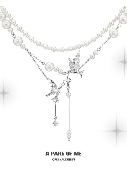 A PART OF ME flying bird pearl necklace featuring elegant design with silver accents and pearl strands