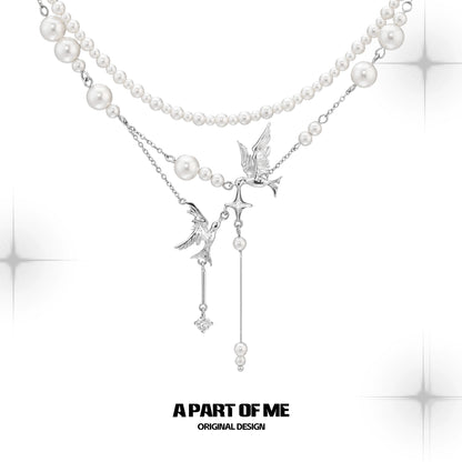 A PART OF ME flying bird pearl necklace featuring elegant bird charms and lustrous pearls