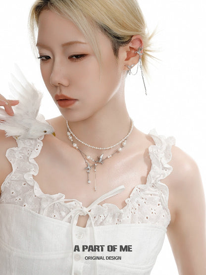 A stylish flying bird pearl necklace featuring delicate pearls and a charming bird pendant