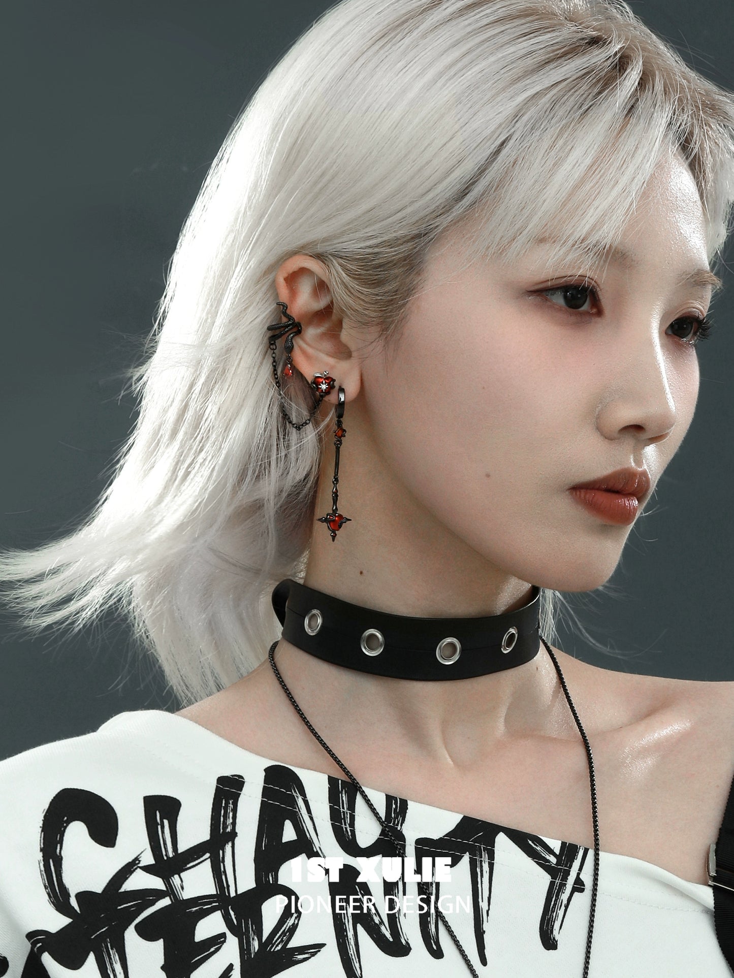 Model wearing forbidden apple serpent earrings with unique design and edgy style