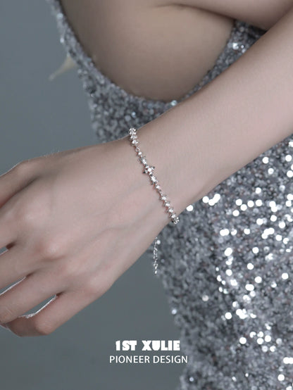 Elegant four-point star silver bracelet showcased on a hand, perfect for stylish occasions
