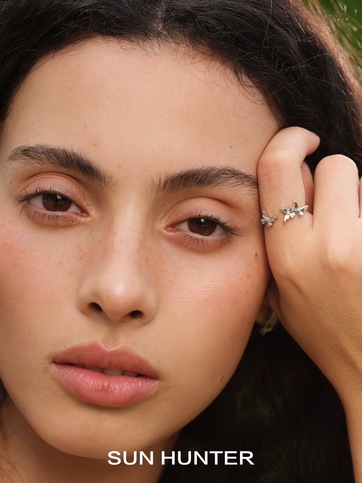 Beautiful model showcasing a SUN HUNTER French retro butterfly ring with intricate detailing