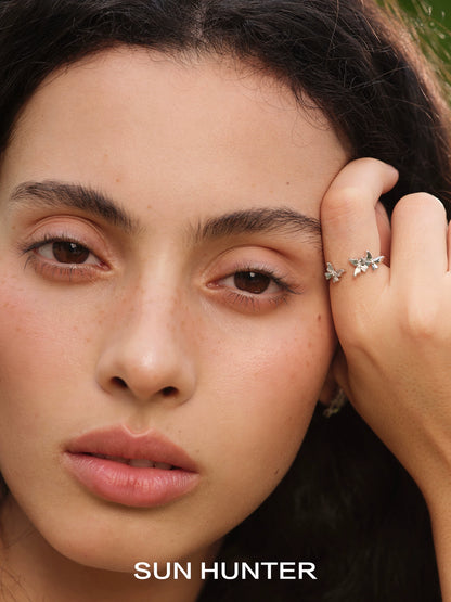 Beautiful model showcasing a SUN HUNTER French retro butterfly ring with intricate detailing