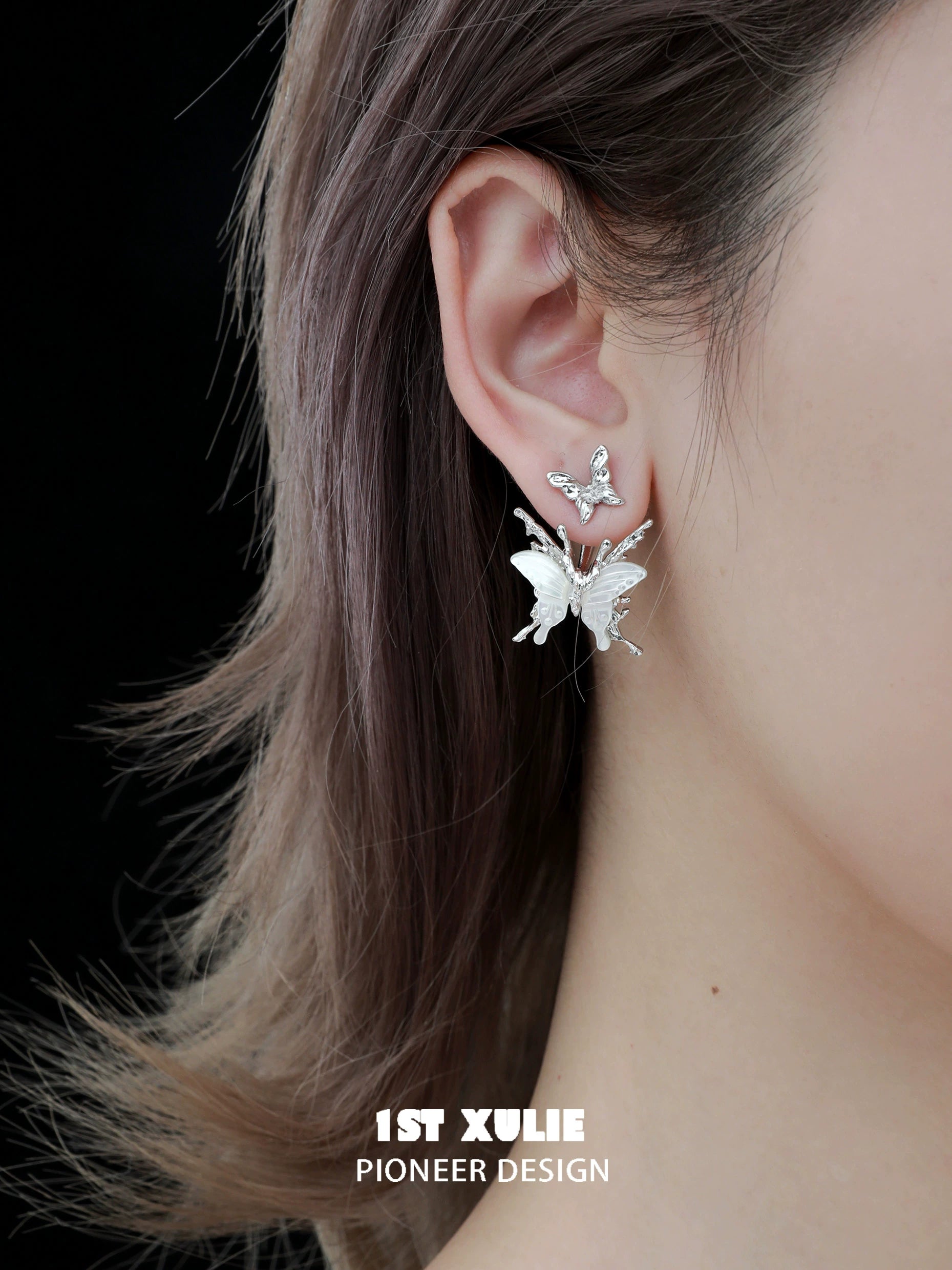Futuristic butterfly earrings by 1ST XULIE with intricate designs and a sleek finish for modern style