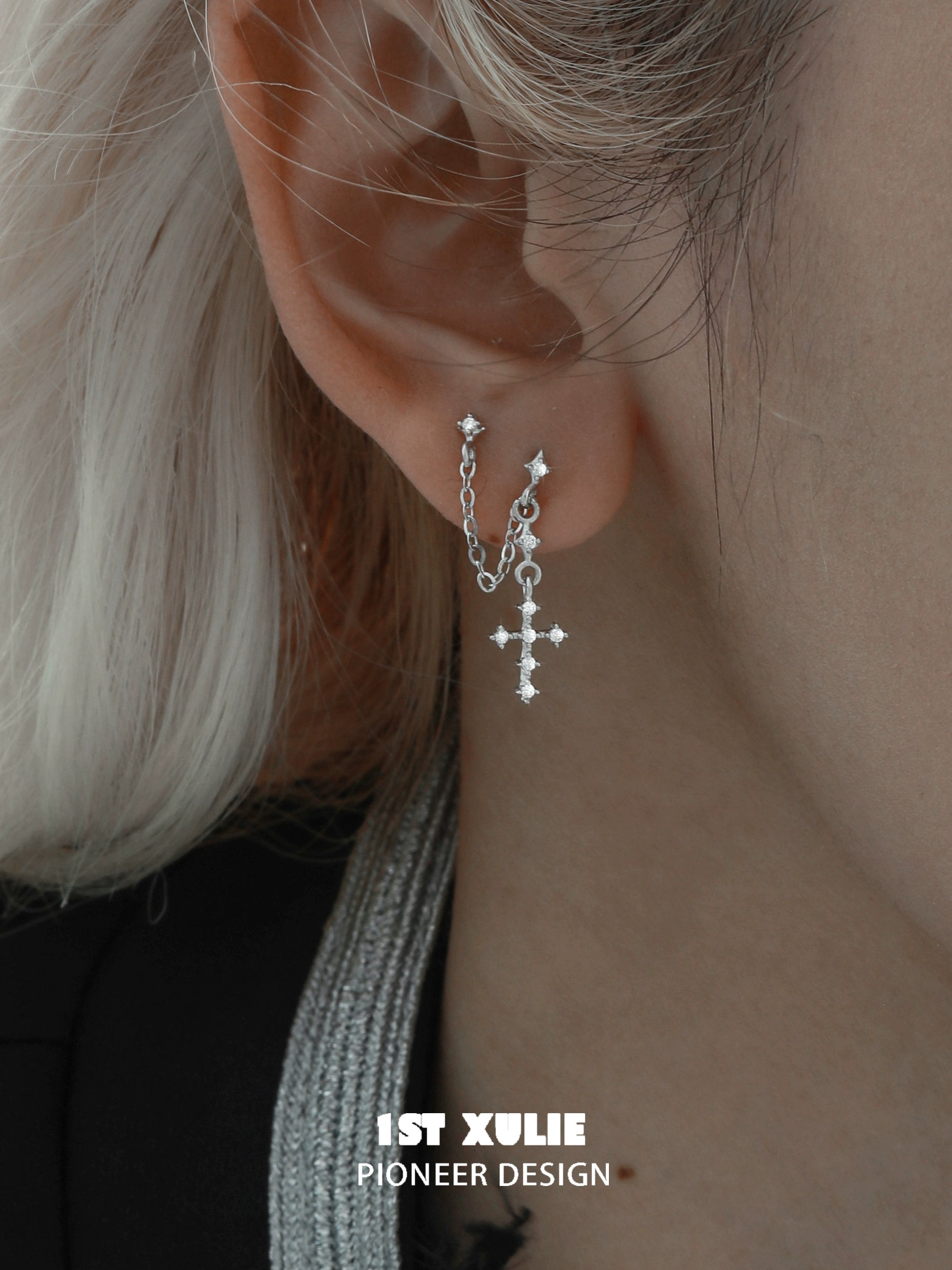 Stylish futuristic cross chain earrings featuring silver chains and sparkling embellishments