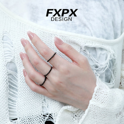 Stylish black tinfoil texture ring worn on fingers, showcasing a modern design by FXPX