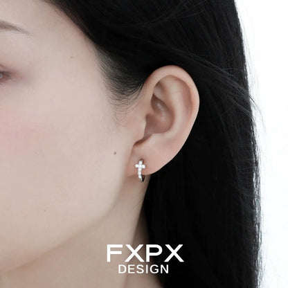 Model wearing bloody doll jewelry gothic cross stud earrings in silver with clear stones