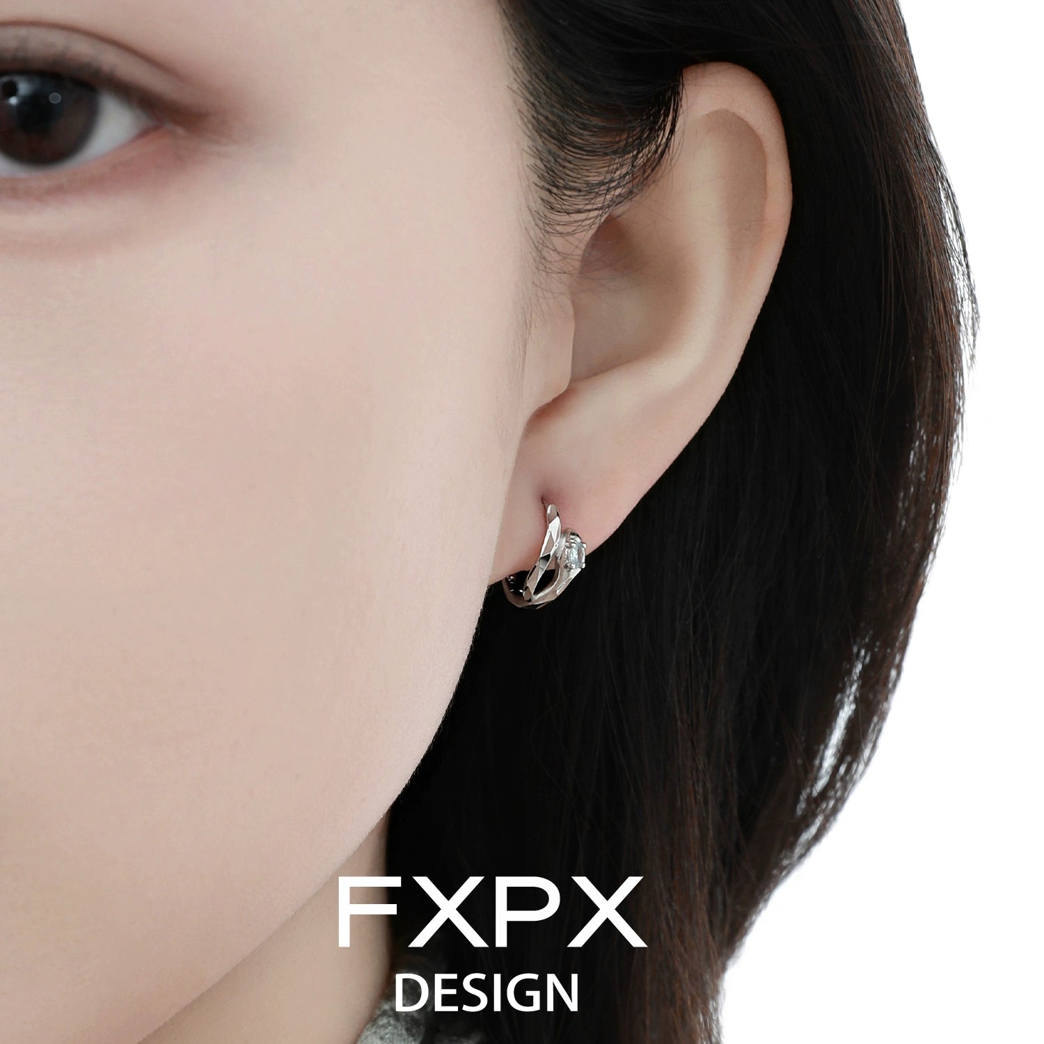 Elegant blue and white serpentine zircon earrings showcased in a close-up view on a model's ear
